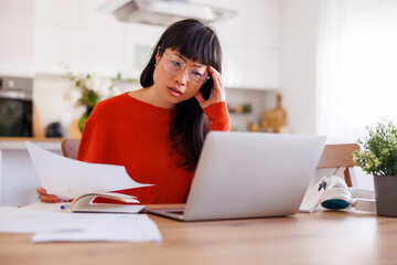 Stressed out woman doing home finances