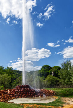 Geysir andernach erupting in a sunny day with blue sky and clouds