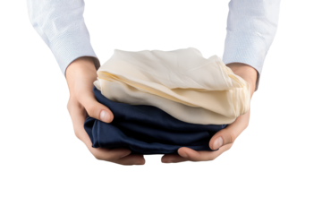 A person holding folded clothes in their hands with a light blue shirt against a black background on transparent background