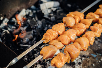 Fresh meat for barbecue, fried on fire. Selective focus. Cooking barbecue on the grill with smoke. Picnic in nature. Healthy food and proper nutrition.