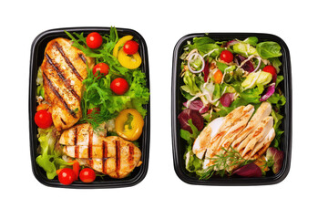 Two black containers holding grilled chicken salads with tomatoes and lettuce on a black background on transparent background