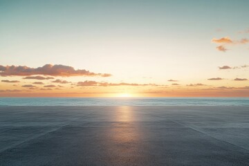 Serene sunset over calm ocean, reflected on empty asphalt