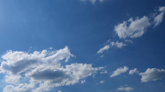Low angle, time-lapse of the white clouds rolling in the blue sky of Deitingen city, Switzerland
