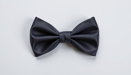 Elegant black bow tie displayed on neutral background fashion accessory studio minimalist style