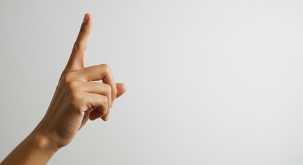 Realistic human hand showing shushing gesture, light plain background, copy space right. Photorealistic visual concept