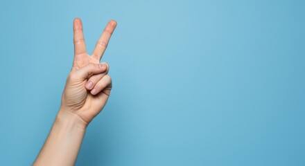 Fototapeta premium Realistic human hand showing bunny ears gesture, bright plain background, copy space right. Photorealistic visual concept