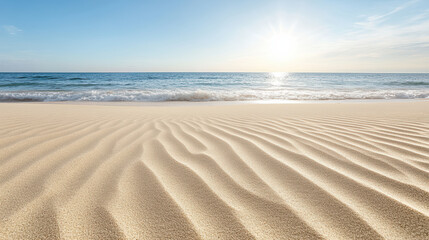 Gentle waves lap against shore, creating patterns on soft sand under warm sun