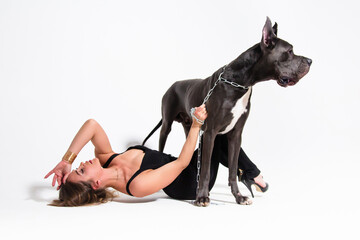 Beautiful slender model dressed in the black suit with dog