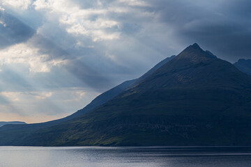 Blue Hour Sunbeams Over Highland Peaks
