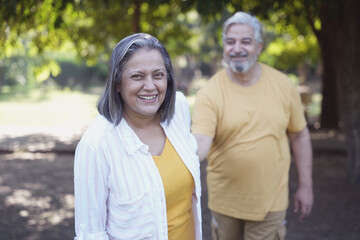 Fototapeta premium Indian happy senior couple fun, relaxing, spend time together at park. Relationship and people concept. Senior Living Retirement and Pension Plans Concept