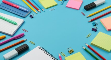 Fototapeta premium Colorful school supplies arranged in a circle on a bright blue background