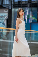Young beautiful woman in a long white dress