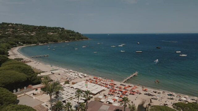 Drone shows beach with people and umbrellas Saint Tropez, France, short panorama