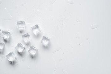 Melting ice cubes in a splash of water on a white background