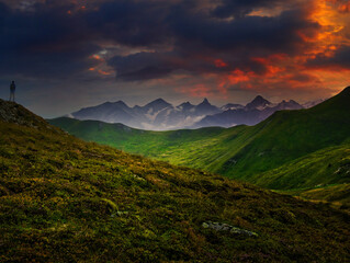 Man tourist watching mountains near Saalbach Hinterglemm Leogang ski resort during summer day, Creative post processing