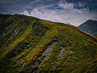 People walking on a mountains range  near Saalbach Hinterglemm Leogang ski resort during summer day