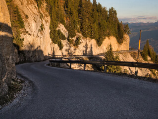 Asphalt road with bends surrounded by rocks and cliffs in a mountains
