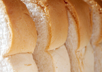 Close-up of freshly sliced ​​soft and fragrant bread with white bread,brown bread crust macro