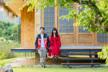 Romantic time together. Happy asian couple tourist sitting on terrace at a Japanese style homestay at countryside on vacation.