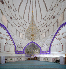 interior architecture of a grand beautiful white mosque in white and blue concept with blue azure color carpet
