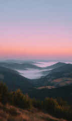 Fototapeta premium Serene dawn breaking over misty mountains as the sun paints the sky with pastel hues of pink