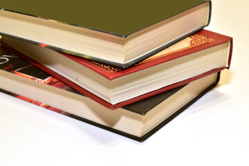 Books lie in a stack on a white background.