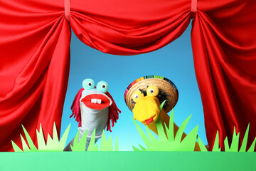 Creative puppet show on stage with decorations and red curtains