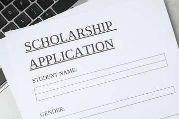Scholarship application form on laptop, top view