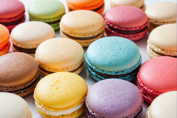 A selection of bright and colorful macarons arranged on a table, perfect for food photography or packaging design