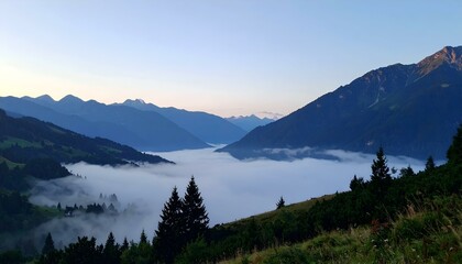 Obraz premium Serene sunrise over misty mountain valley. Breathtaking view of alpine landscape with fog.