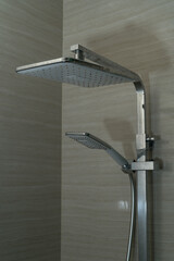 Shower head spraying water inside a modern bathroom
