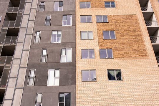 High-rise residential building with mixed materials and tones, featuring a strong vertical perspective ideal for abstract design and architectural contrasts.
