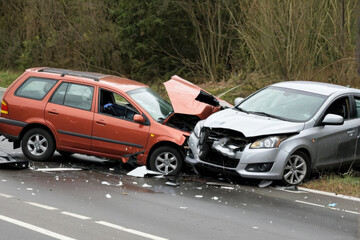 Naklejka premium Two vehicles crashed on the roadside with debris scattered around