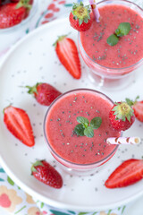 Strawberry smoothie with chia seeds in a glass. Top view.  Healthy summer drink.