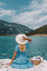 Woman with blonde hair sitting on boat in Southern France