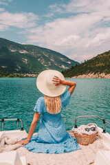 Woman with blonde hair sitting on boat in Southern France