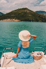 Woman with blonde hair sitting on boat in Southern France