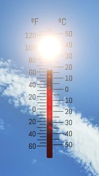 A thermometer displays extreme heat on a bright sunny day with scattered clouds. Ideal concept for summer heatwaves, climate change, or rising global temperatures