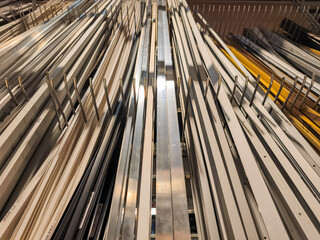 Metal profiles are neatly arranged and waiting in a warehouse