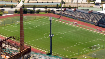 Aerial view of the municipal stadium of Gaeta, in the province of Latina, Lazio, Italy. It is a grass soccer field.
