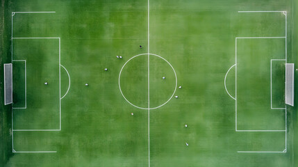 Soccer field with players in action on green grass during match, showing goalposts and field markings from aerial view with dynamic sports energy