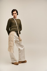Fashionable non binary individual showcases unique style in urban setting