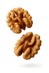 Two whole walnut kernels with detailed textures suspended on transparent background.