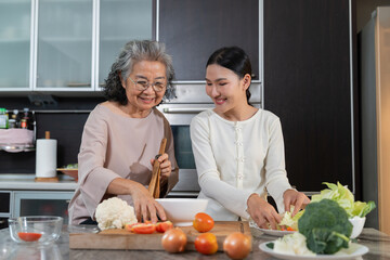 Fototapeta na wymiar In the kitchen, a daughter and her elderly mother share a special bonding moment through cooking. Their care reflects family values, showcasing the role of a caregiver in retirement lifestyles