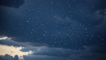 Naklejka premium rain droplets in motion against a dark sky background, copy space at the bottom.