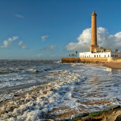Fototapeta premium Chipiona, Spain. Chipiona Lighthouse on the Ocean Shore 