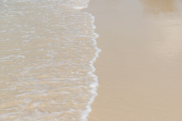 Soft wave on sandy beach. Background.