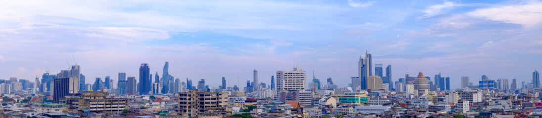 Panoramic skyline of Bangkok city with modern skyscrapers under blue sky