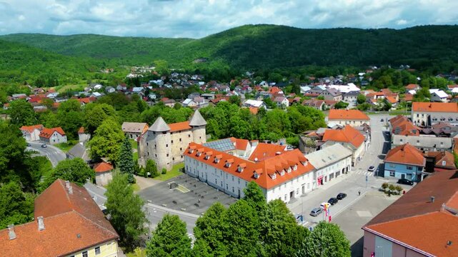 Ogulin, Croatia from the air &ndash; Heritage Museum, Hotel Frankopan, train station, Church of the Holy Cross and Klek mountain in the background. Historic charm meets natural beauty
