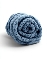 Cozy blue knitted throw blanket, rolled up.